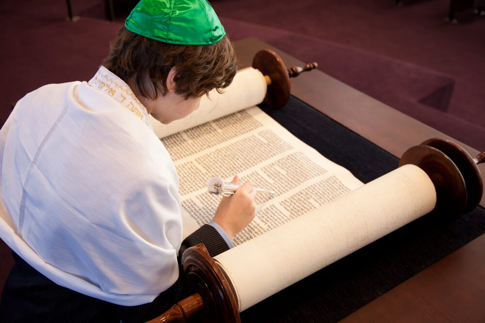 Jewish boy writing in a sacred text
