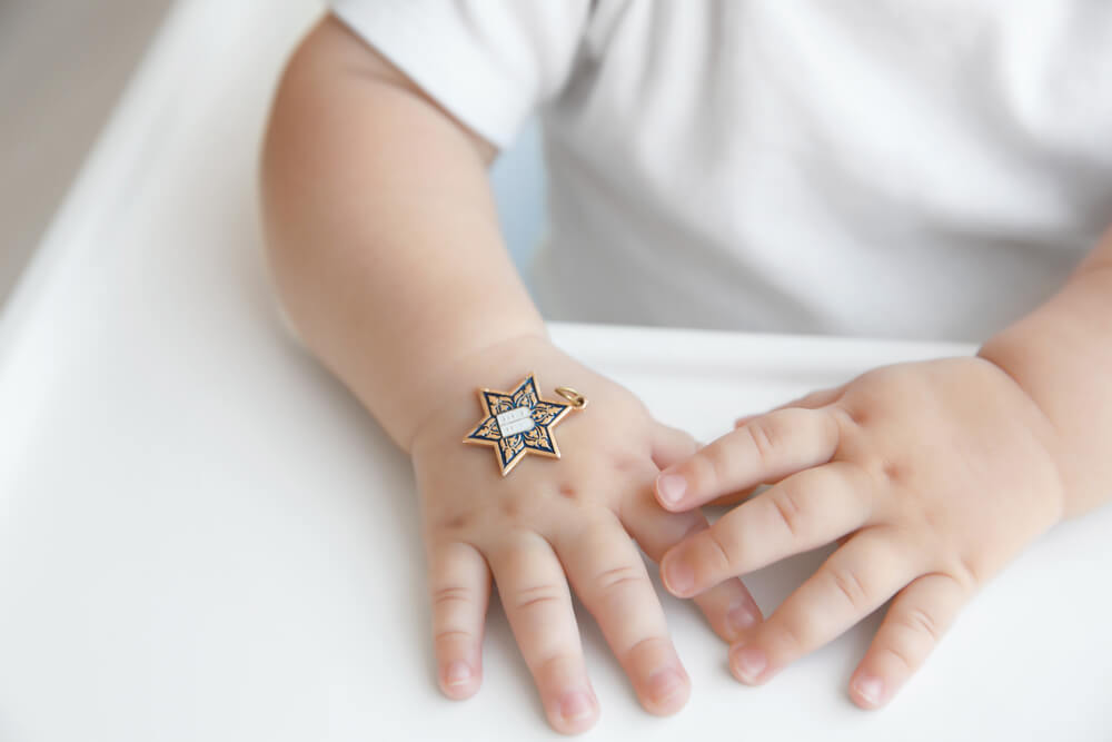 Jewish baby boy hands close up