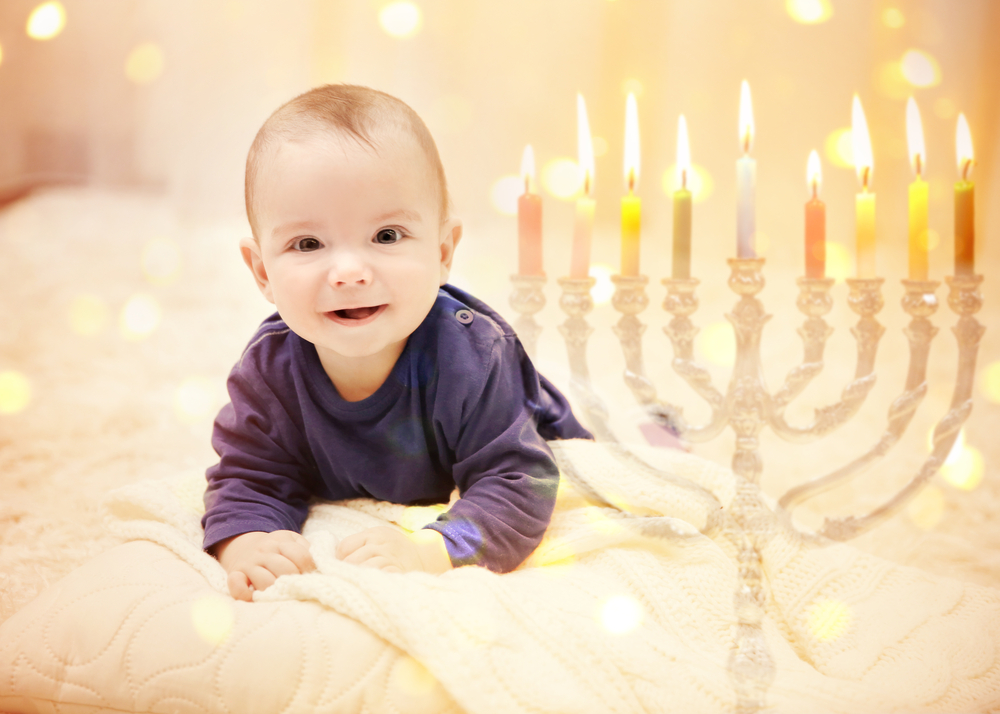 Little Child on Blurred Festive Lights Background Babys First Hanukkah